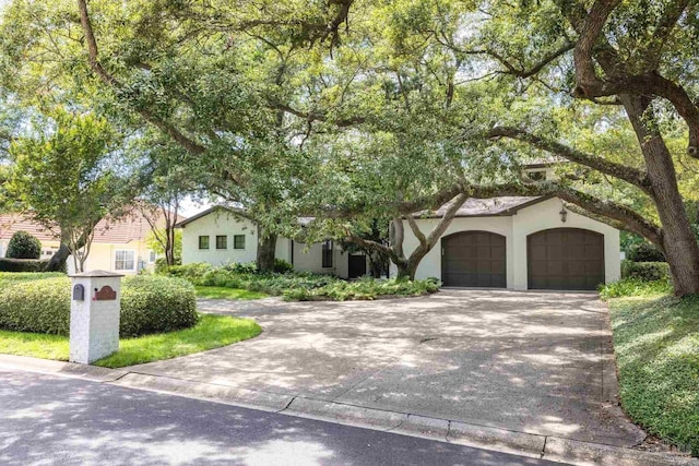 9 N Sunset Blvd, Gulf Breeze, FL 32561 - view of front of home with stucco siding, an attached garage, and concrete driveway