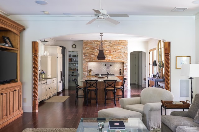 9 N Sunset Blvd, Gulf Breeze, FL 32561 - living area featuring arched walkways, ornamental molding, dark wood-type flooring, and a ceiling fan