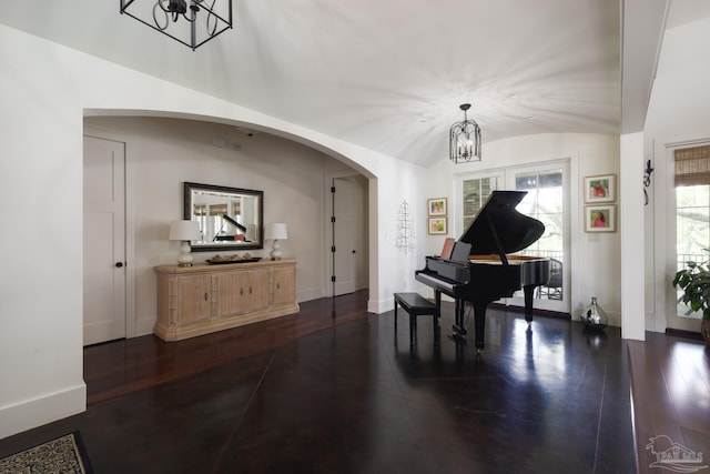 9 N Sunset Blvd, Gulf Breeze, FL 32561 - sitting room with a chandelier, arched walkways, vaulted ceiling, and dark wood-type flooring