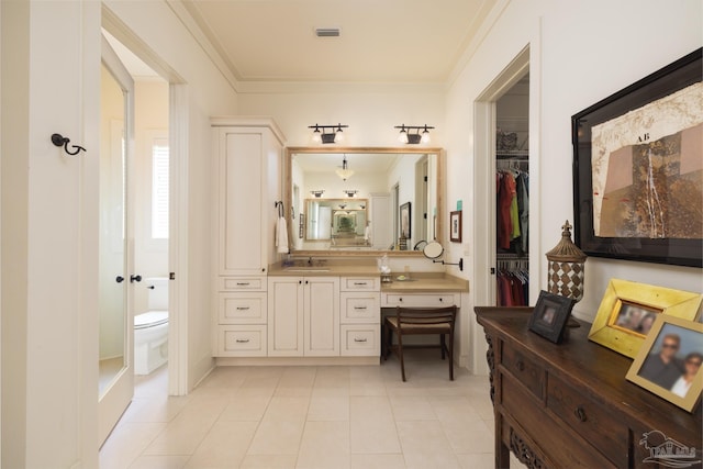 9 N Sunset Blvd, Gulf Breeze, FL 32561 - full bathroom featuring ornamental molding, vanity, tile patterned floors, and a spacious closet