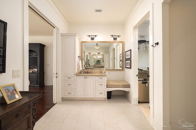 9 N Sunset Blvd, Gulf Breeze, FL 32561 - bathroom with vanity, crown molding, a spacious closet, and tile patterned floors