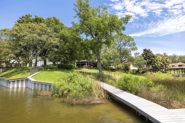 9 N Sunset Blvd, Gulf Breeze, FL 32561 - dock area featuring a water view and a lawn