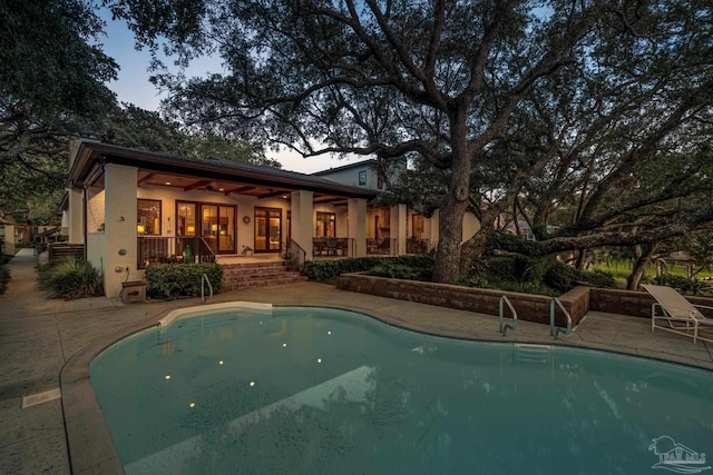 9 N Sunset Blvd, Gulf Breeze, FL 32561 - rear view of house with stucco siding, a patio area, an outdoor pool, and ceiling fan