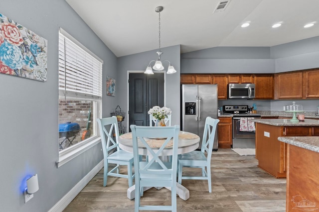 kitchen featuring visible vents, brown cabinets, stainless steel appliances, and light wood-style flooring