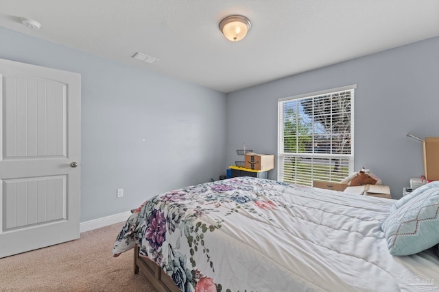 carpeted bedroom featuring visible vents and baseboards