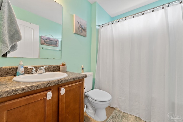 full bathroom with vanity, tile patterned floors, curtained shower, and toilet