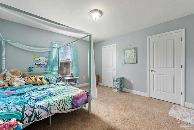 bedroom featuring carpet flooring and baseboards