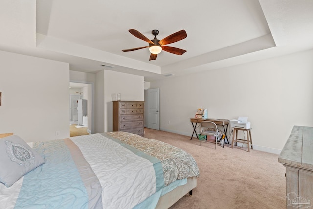 bedroom featuring a tray ceiling, carpet flooring, visible vents, and baseboards