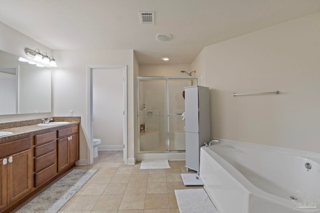 bathroom featuring visible vents, a sink, a shower stall, a garden tub, and toilet