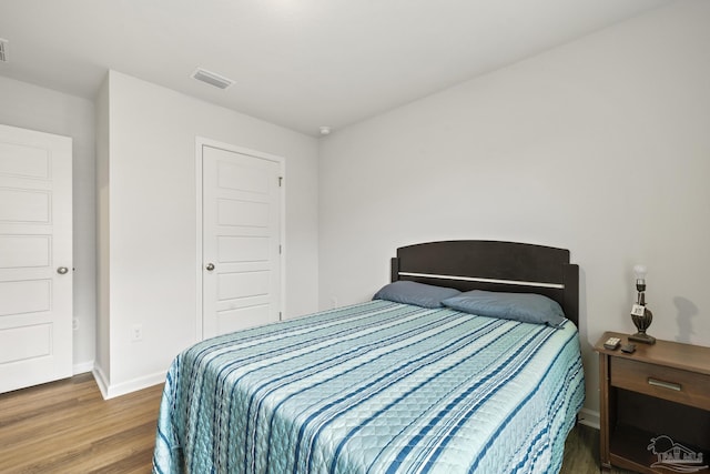 bedroom with hardwood / wood-style floors