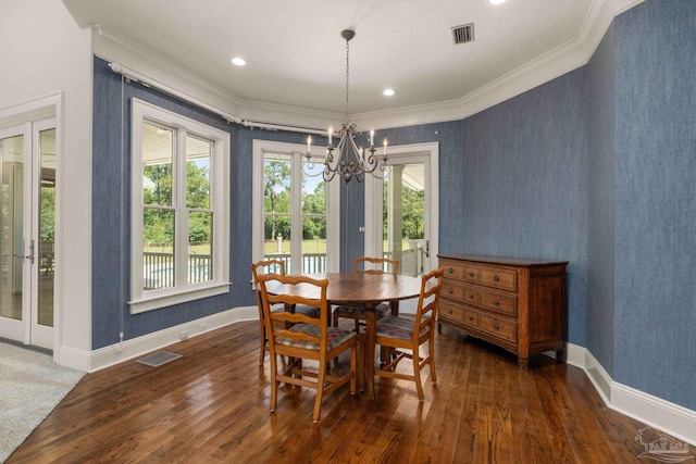 dining space featuring crown molding, a notable chandelier, and dark hardwood / wood-style flooring