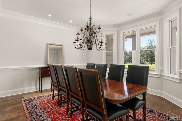 dining area with a notable chandelier, ornamental molding, and dark hardwood / wood-style floors