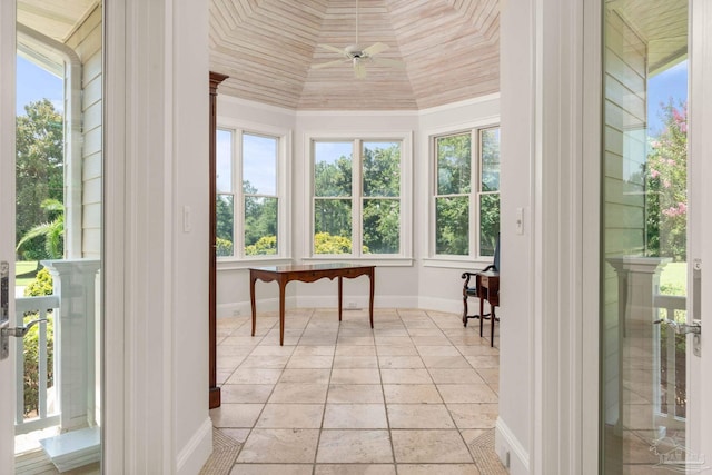 sunroom featuring ceiling fan and plenty of natural light