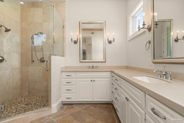 bathroom featuring vanity and a shower with shower door