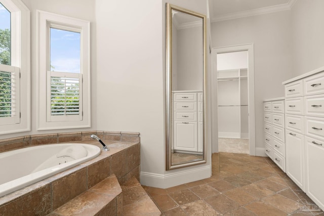 bathroom with tiled tub and crown molding