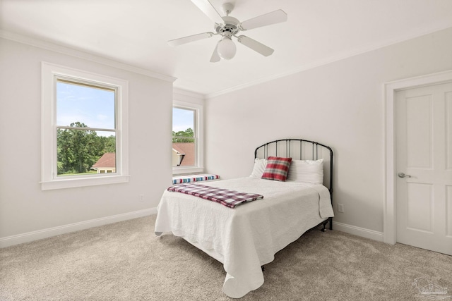 carpeted bedroom featuring ornamental molding and ceiling fan