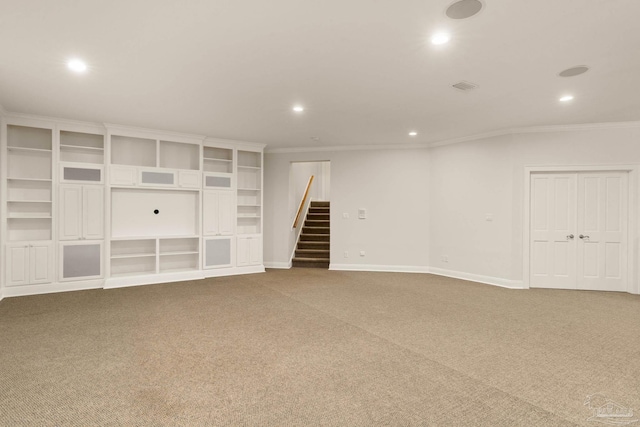 interior space featuring crown molding and carpet