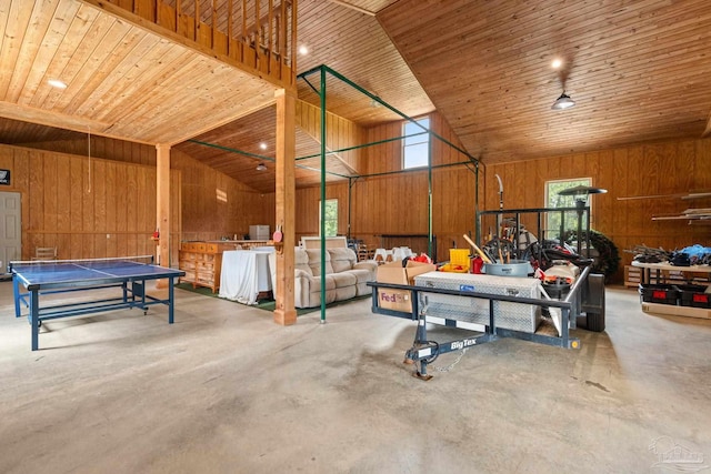 garage featuring wood ceiling and wooden walls