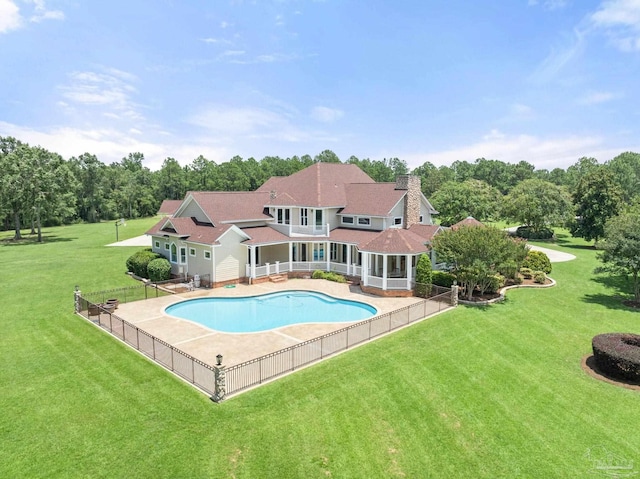 view of pool with a patio area and a lawn