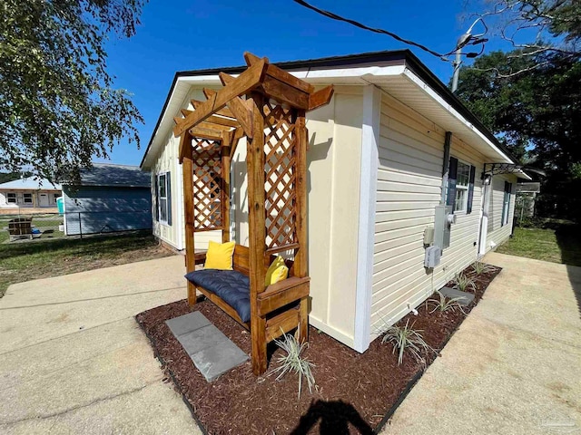 view of side of property featuring a pergola