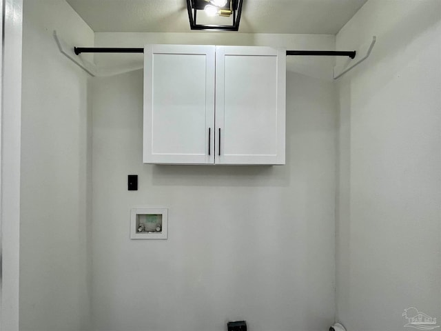 laundry room with hookup for a washing machine, hookup for an electric dryer, and cabinets