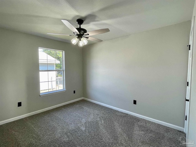 carpeted spare room with ceiling fan