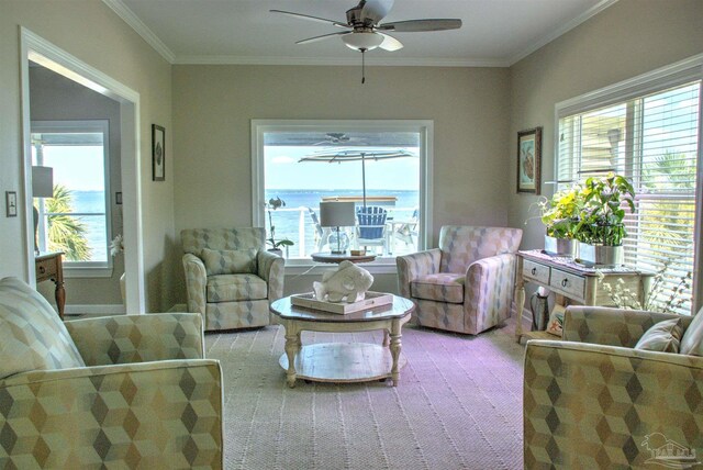 living room with carpet floors, crown molding, ceiling fan, and a healthy amount of sunlight