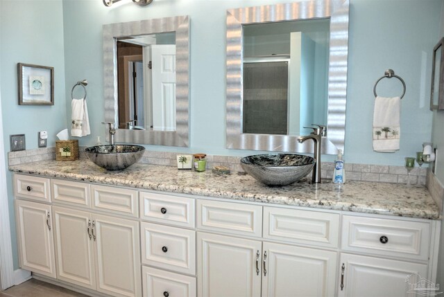 bathroom featuring tile patterned flooring and an enclosed shower