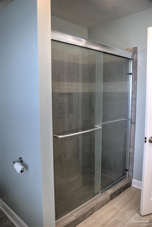 laundry area featuring separate washer and dryer, light tile patterned floors, plenty of natural light, and cabinets