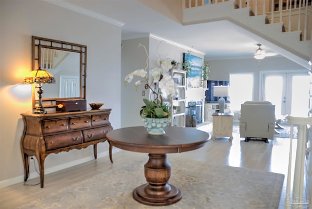 interior space featuring light hardwood / wood-style floors and crown molding