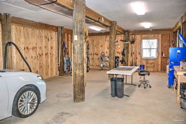 basement featuring wooden walls