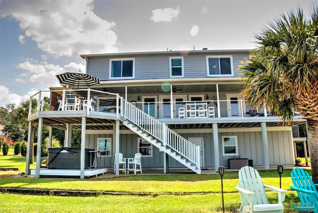 back of property with a deck and a lawn