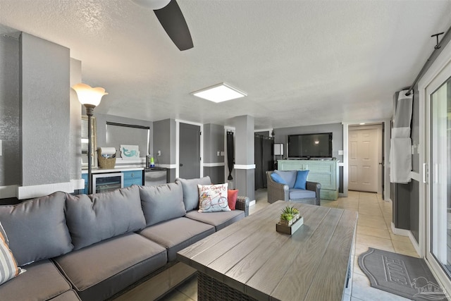 living area with a textured ceiling and light tile patterned floors