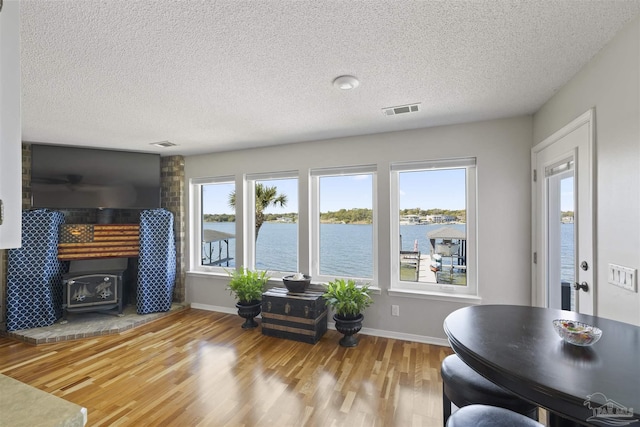 living room with visible vents, baseboards, and wood finished floors