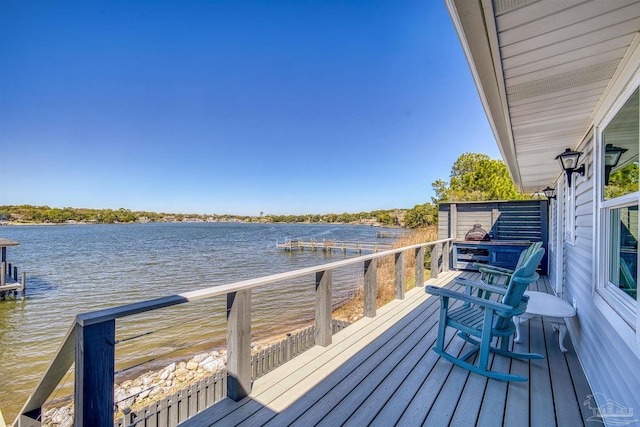 wooden deck featuring a water view