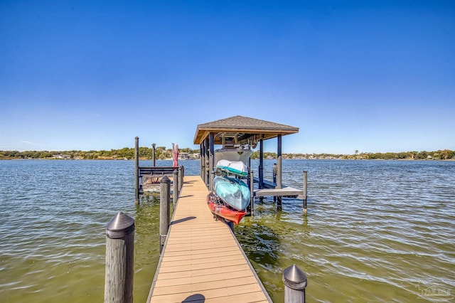 dock area with a water view and boat lift