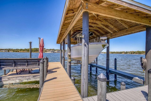 view of dock featuring a water view and boat lift