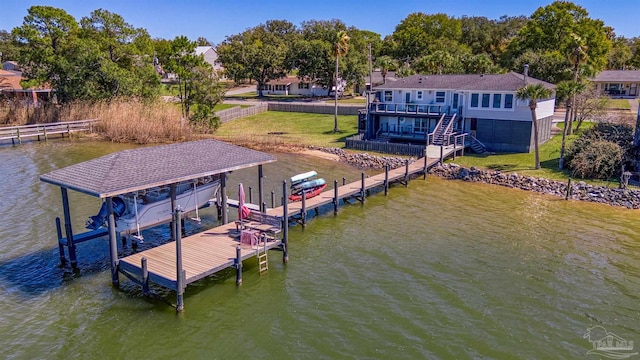 view of dock featuring a lawn, a water view, and boat lift