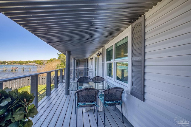 wooden terrace featuring a water view