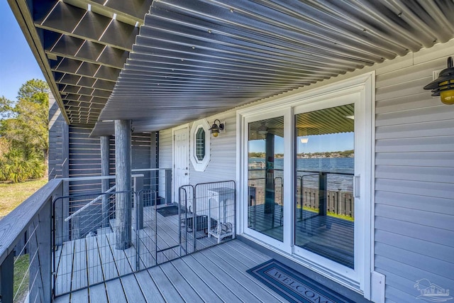 wooden deck featuring a water view