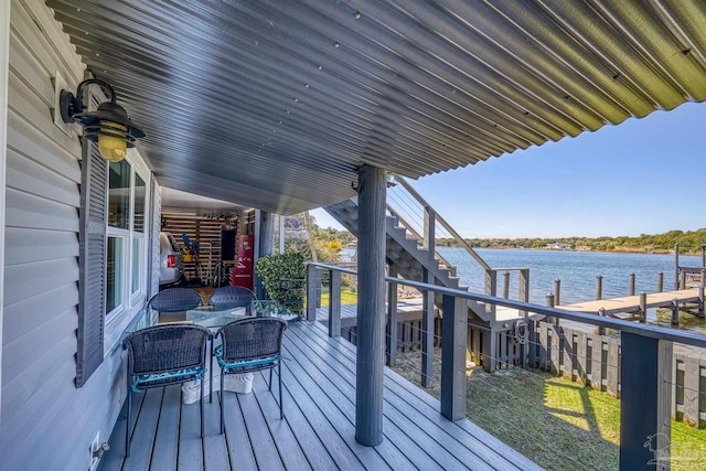 wooden terrace featuring a water view