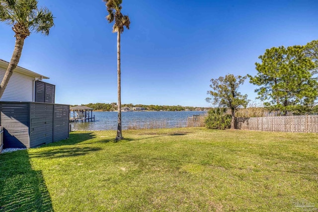 view of yard with a water view and fence