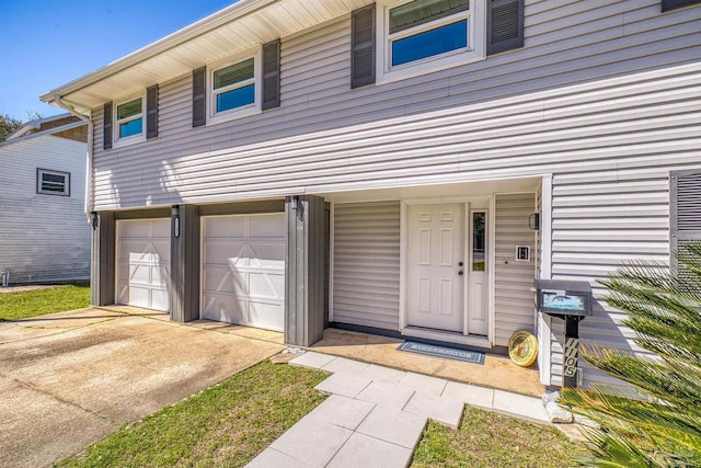 exterior space with concrete driveway and an attached garage