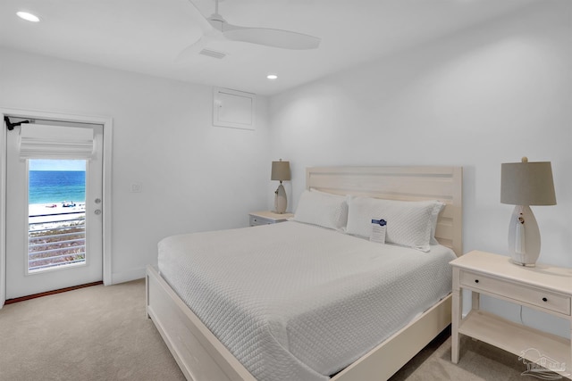 carpeted bedroom featuring a water view, access to exterior, and ceiling fan