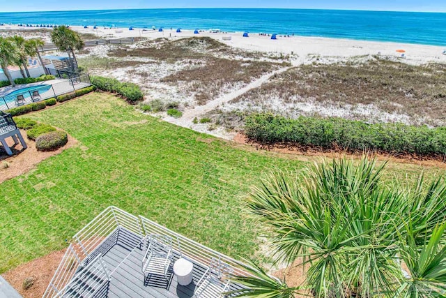 aerial view with a water view and a beach view