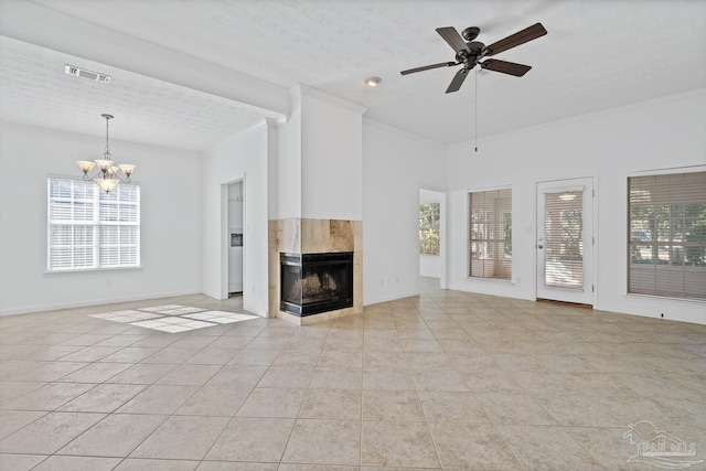 unfurnished living room with a tile fireplace, a healthy amount of sunlight, and light tile patterned flooring