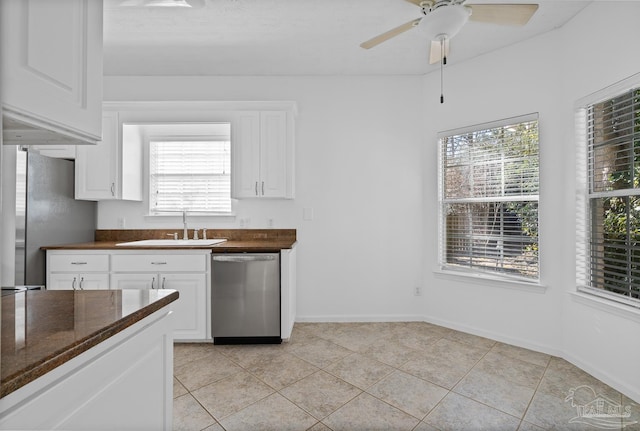 kitchen with white cabinetry, sink, light tile patterned floors, and stainless steel appliances