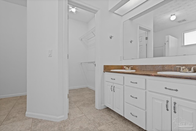 bathroom featuring vanity, tile patterned floors, and a textured ceiling