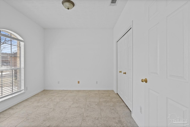 unfurnished bedroom featuring light tile patterned flooring