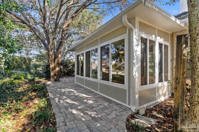 view of home's exterior featuring a patio area and a sunroom